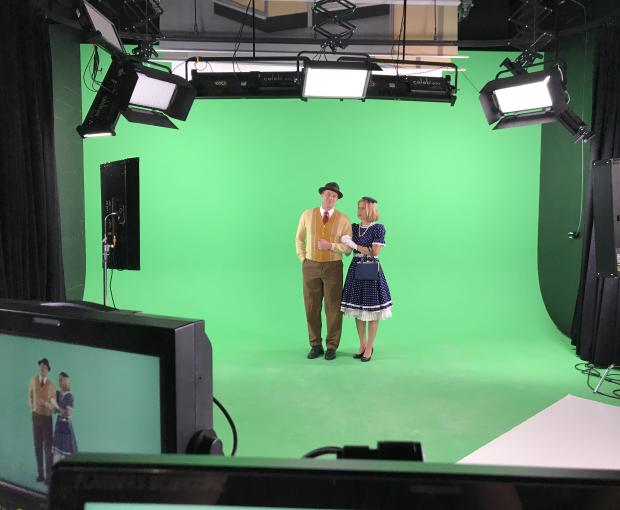 Couple in vintage clothes on green screen set